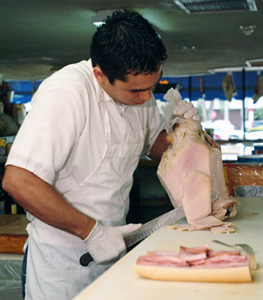 Man cutting pork roast